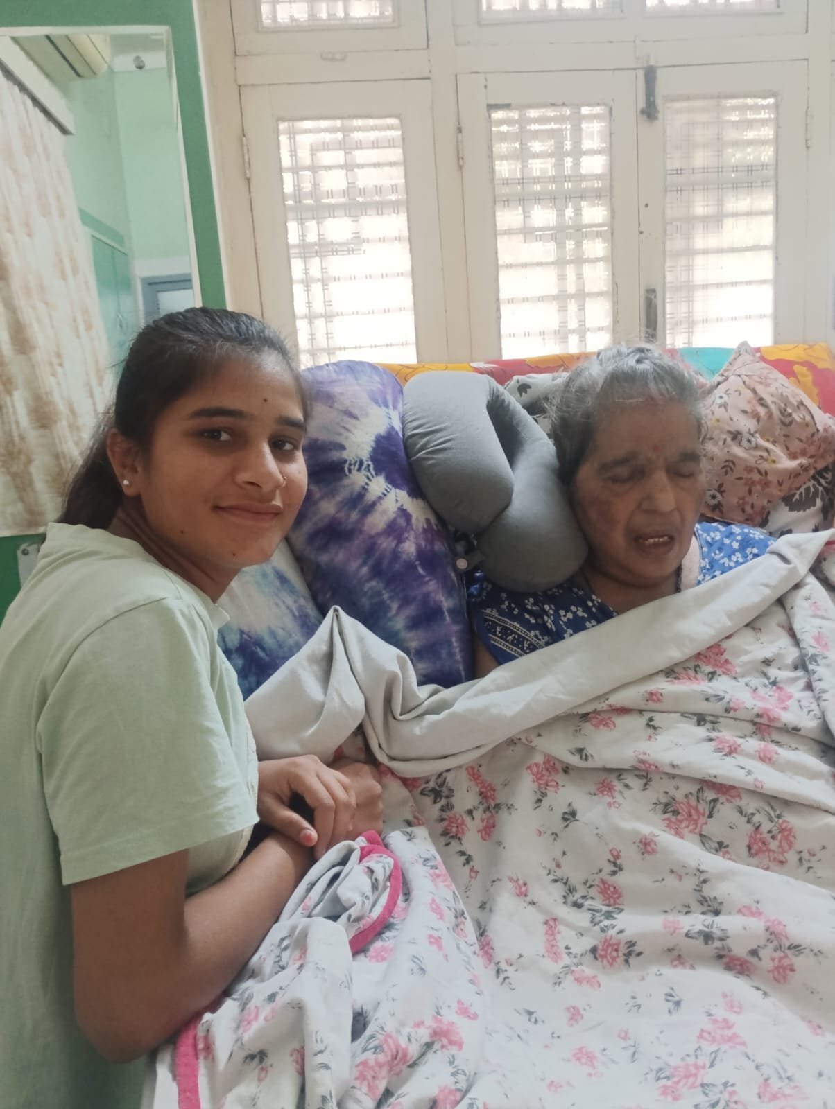 Caregiver beside a patient in bed