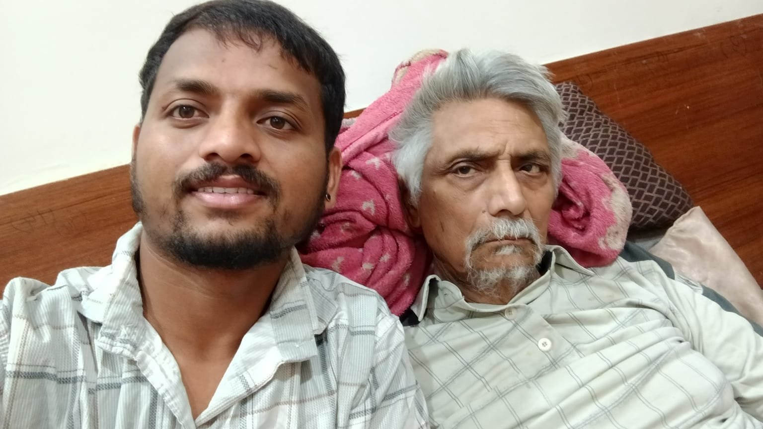 Home caregiver with patient in bed